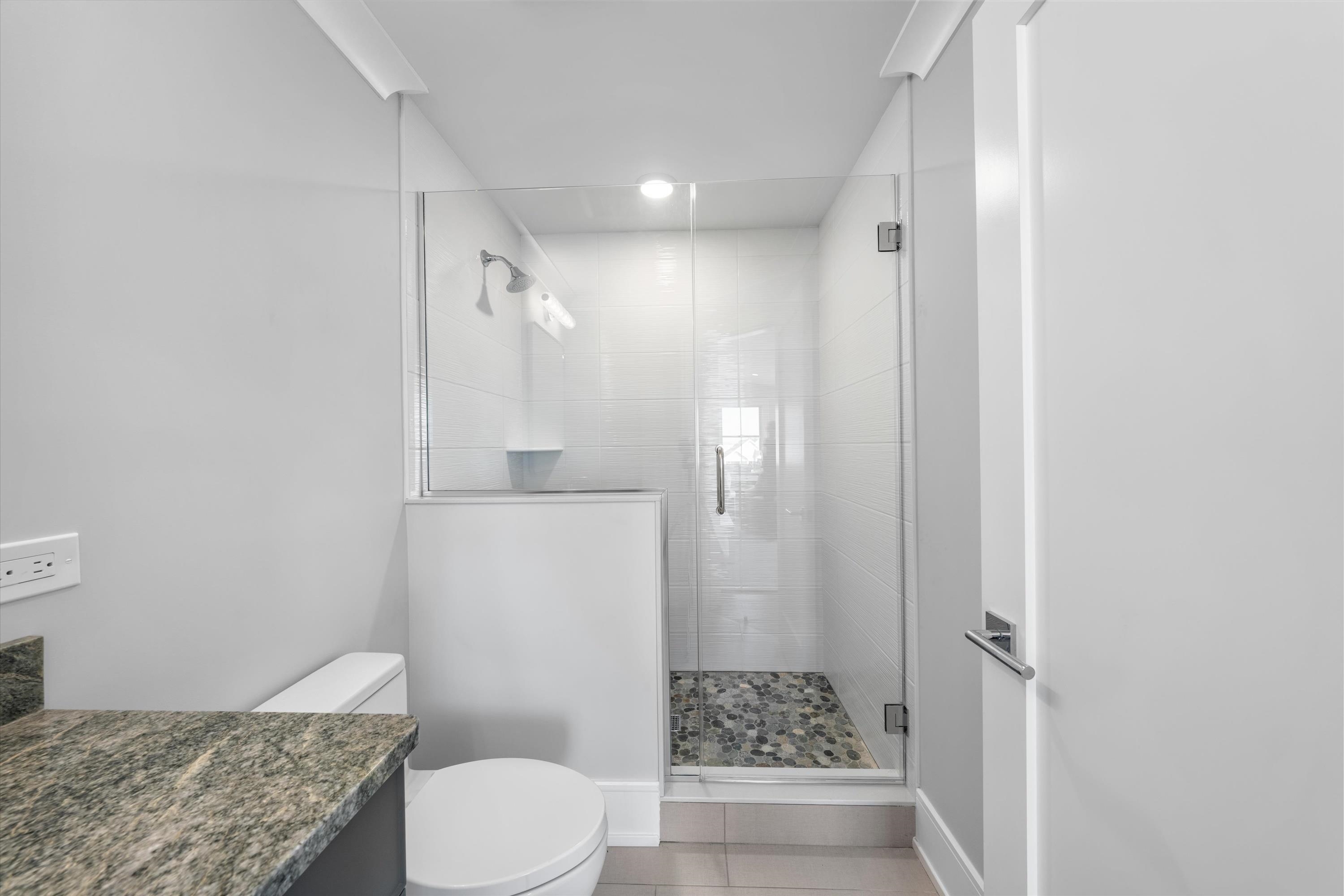 245 57th Street Avalon, NJ 08202 - Photo 41 of 50 a bathroom with a granite countertop sink toilet and shower