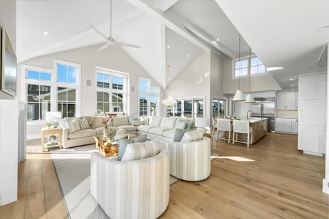 a living room with lots of furniture and a wooden floor