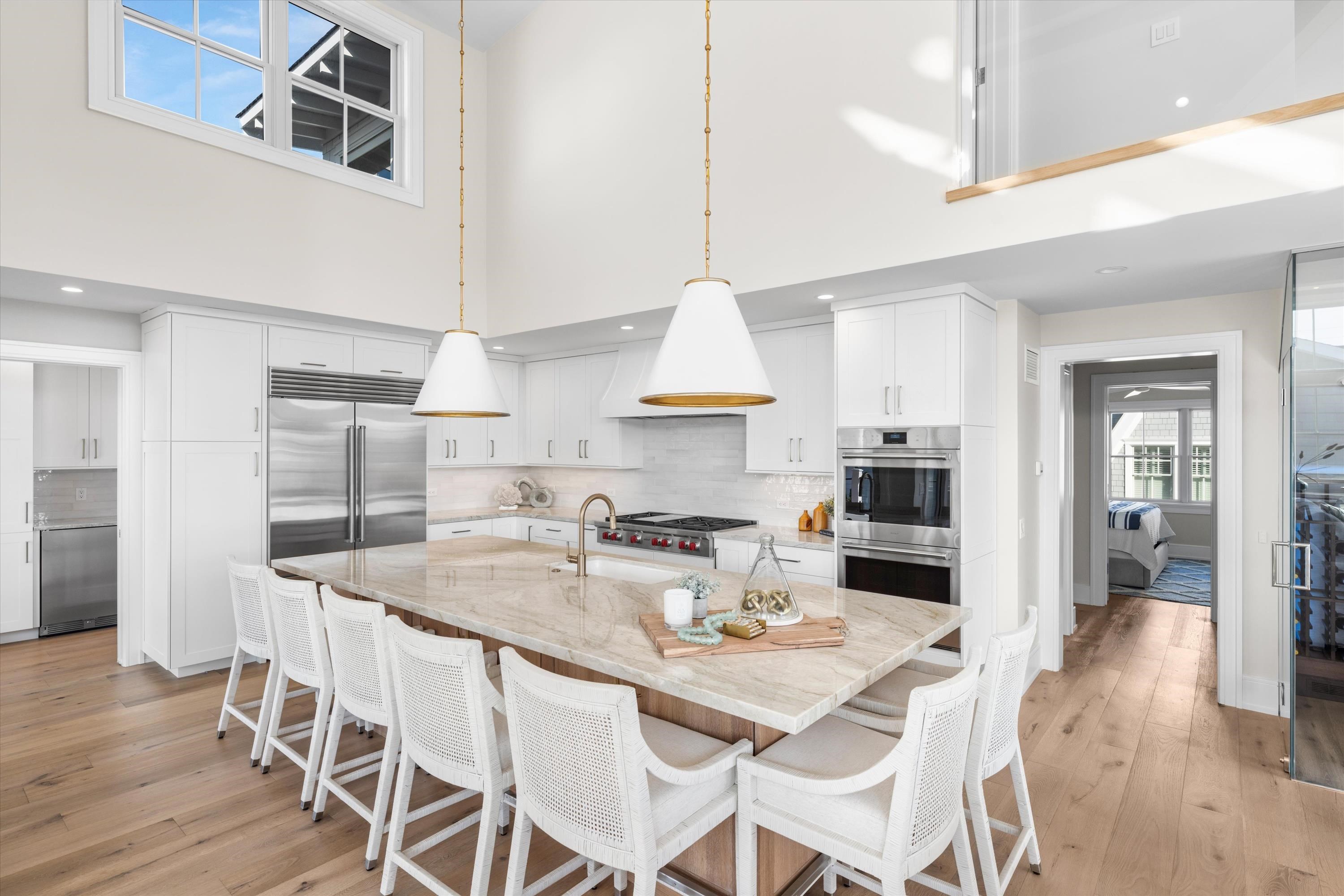 245 57th Street Avalon, NJ 08202 - Photo 7 of 50 a kitchen with stainless steel appliances kitchen island granite countertop a dining table chairs and a refrigerator