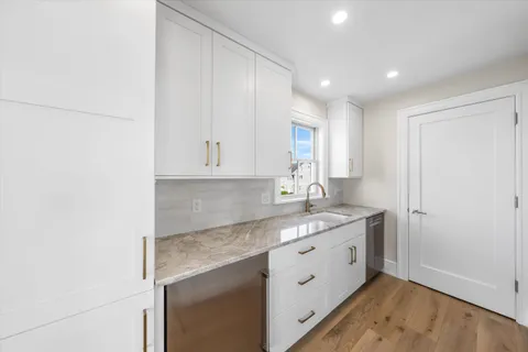 a kitchen with a sink cabinets and window