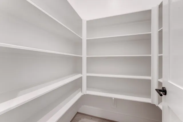 a view of walk in closet with empty racks