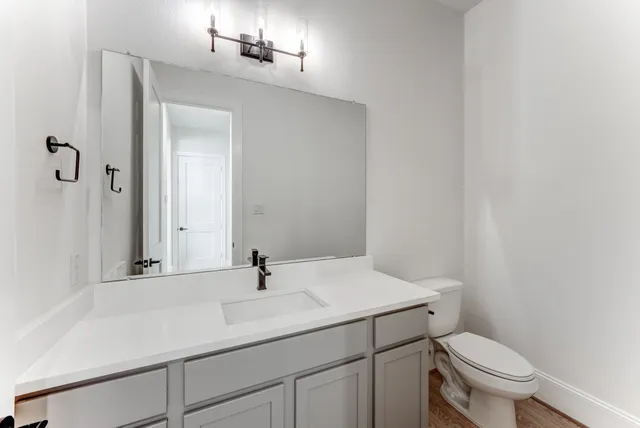a bathroom with a sink toilet and vanity