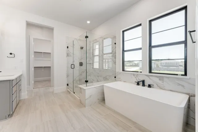 a spacious bathroom with sink shower and bathtub
