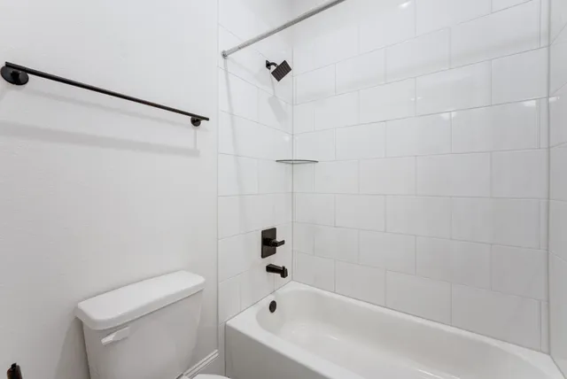 a bathroom with a bathtub and a toilet