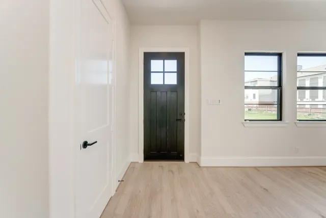 an empty room with windows and closet