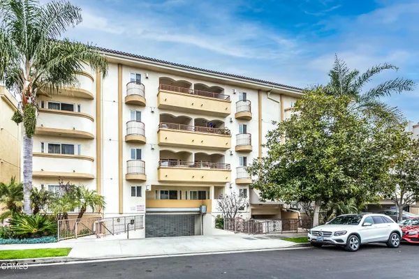 a couple of cars parked in front of a building
