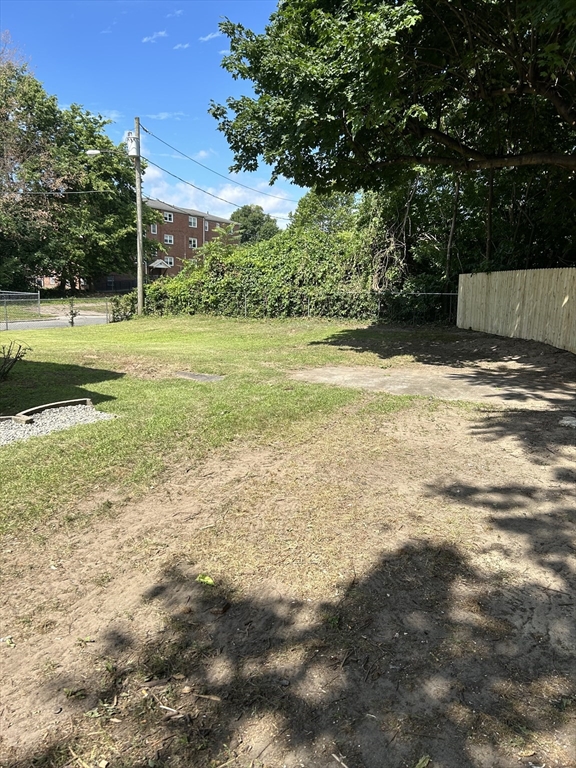 26 Pine St Court Springfield, MA 01105 - Photo 11 of 17 a view of a swimming pool with a yard and large trees