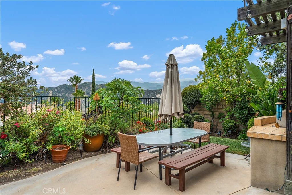 25730 Hawthorne Place Stevenson Ranch, CA 91381 - Photo 37 of 41 a view of a backyard with plants and a patio