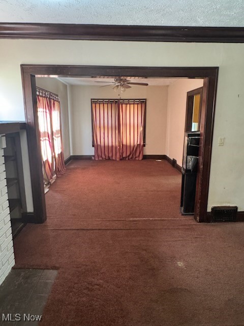 870 Helmsdale Road Cleveland Heights, OH 44112 - Photo 3 of 20 Empty room with dark carpet, a ceiling fan, and crown molding