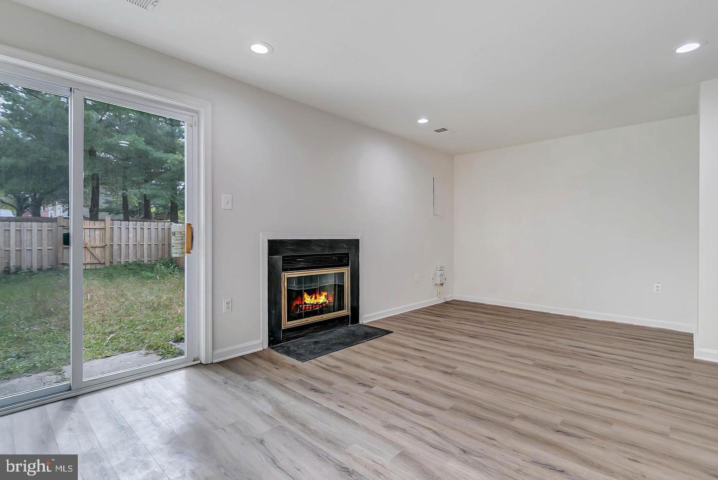 12110 Sweet Clover Drive Silver Spring, MD 20904 - Photo 13 of 13 a view of empty room with wooden floor and fireplace