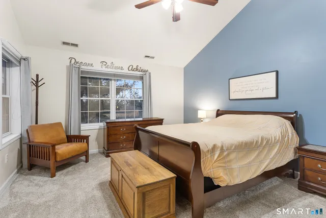 a bedroom with a bed and a couch