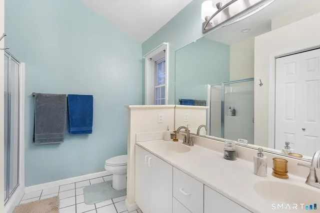 a bathroom with a sink toilet and mirror