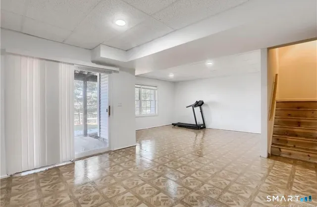 a view of a livingroom with a staircase and a window