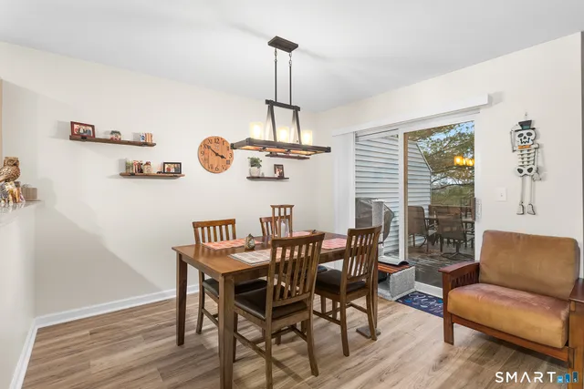 a view of a dining room with furniture wooden floor and a chandelier