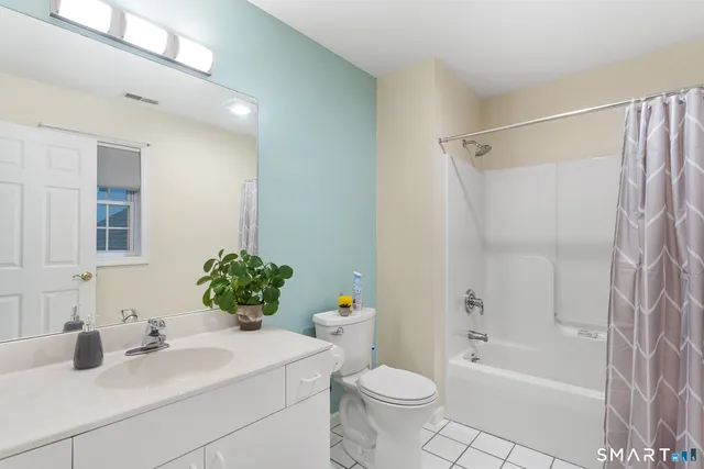 a bathroom with a sink toilet tub and shower