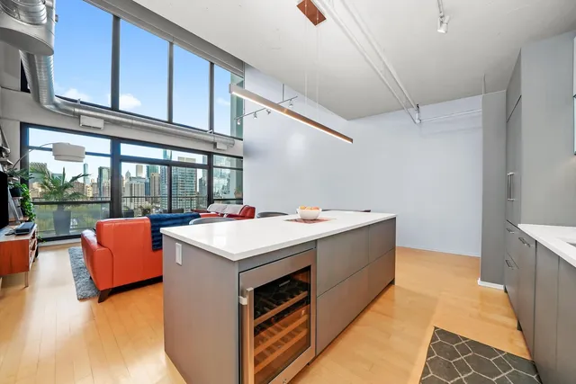 a view of kitchen with stainless steel appliances granite countertop a stove and a refrigerator