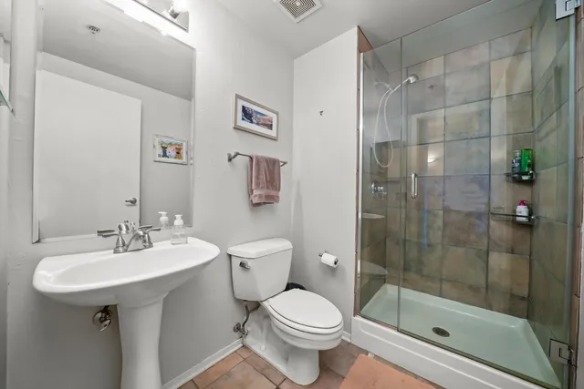 a bathroom with a sink toilet and shower
