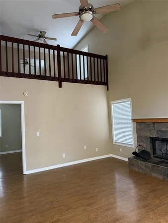 a view of a livingroom with fireplace and a window