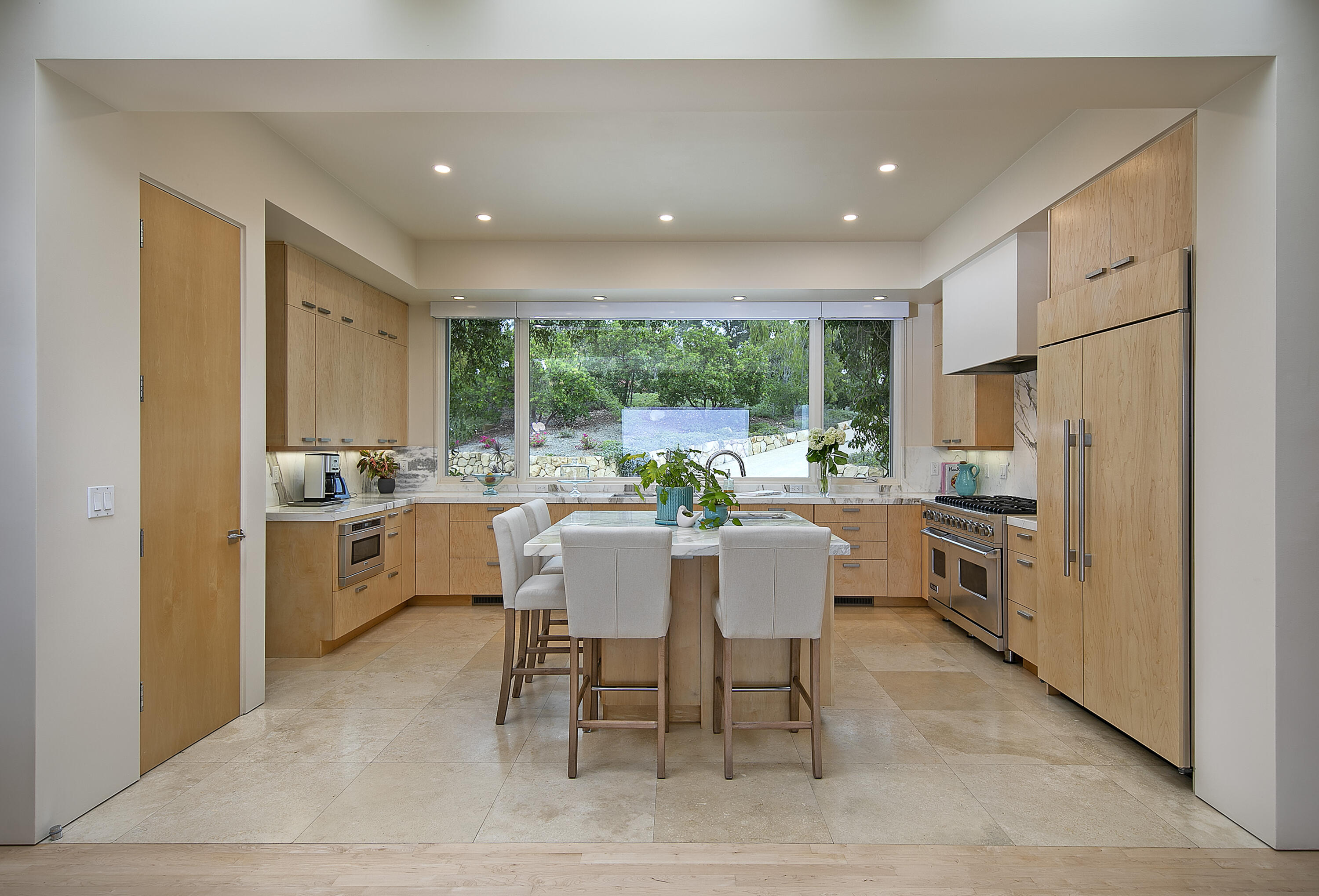 303 Meadowbrook Drive Santa Barbara, CA 93108 - Photo 7 of 28 a kitchen with a table chairs refrigerator and cabinets