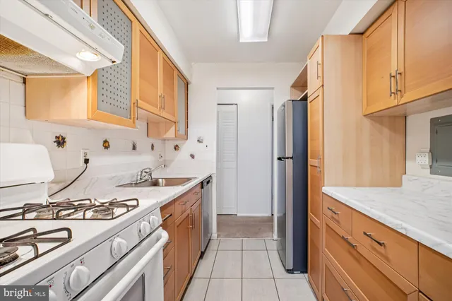 a kitchen with a sink stove and refrigerator