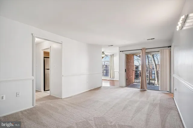 an empty room with windows and closet