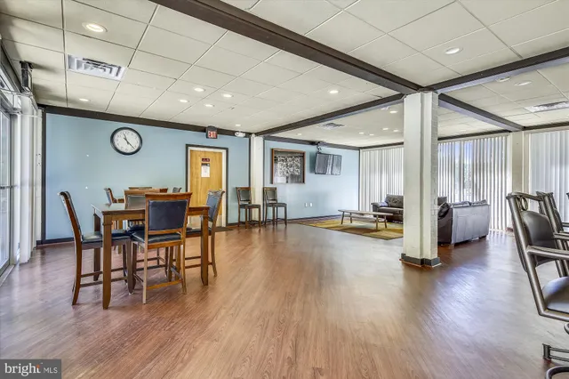 a living room with furniture wooden floor and a table