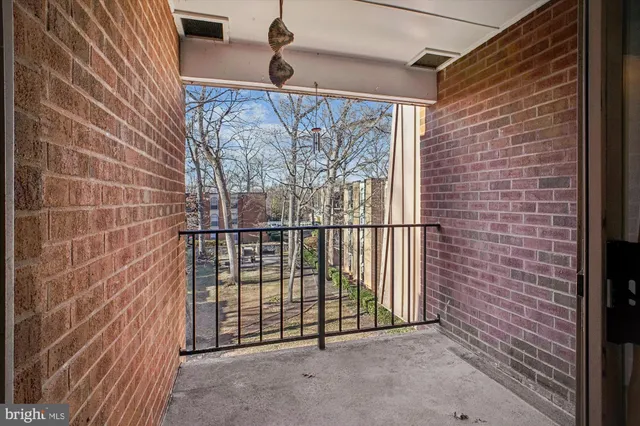 a view of a brick house with a floor to ceiling window and brick wall