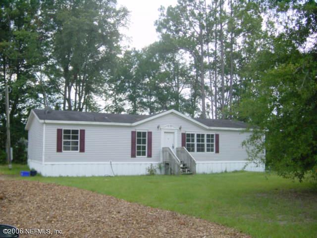 112 Brickyard Road Middleburg, FL 32068 - Photo 1 of 5 a front view of a house with a garden