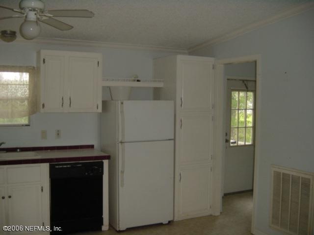 112 Brickyard Road Middleburg, FL 32068 - Photo 3 of 5 a white refrigerator freezer sitting inside of a kitchen