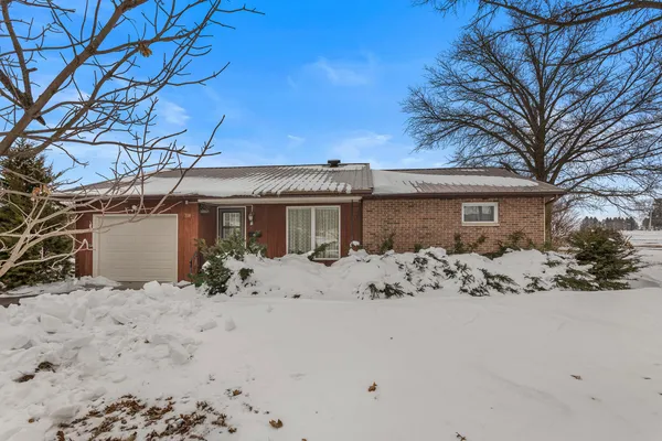 a view of a house with snow on the background
