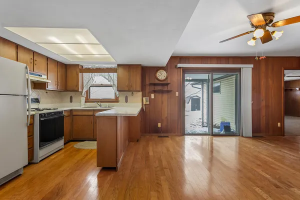 a kitchen with stainless steel appliances granite countertop a refrigerator a stove a sink and a refrigerator