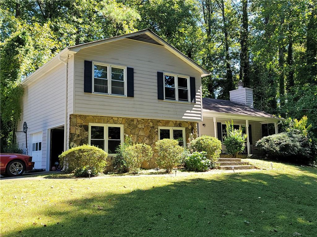 1374 Barrier Road Marietta, GA 30066 - Photo 1 of 1 a front view of a house with a yard