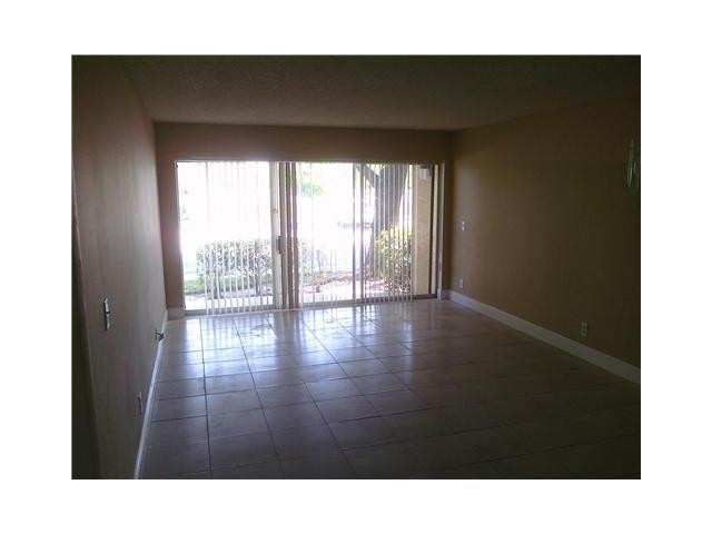 8977 Wiles Road, Unit 2105 Coral Springs, FL 33067 - Photo 5 of 7 a black and white photo of a living room