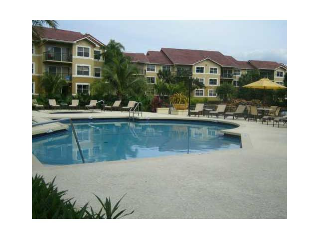8977 Wiles Road, Unit 2105 Coral Springs, FL 33067 - Photo 6 of 7 a view of a house with a swimming pool