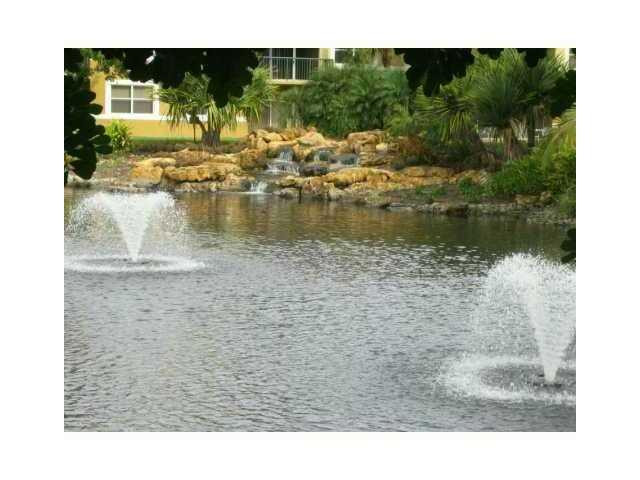 8977 Wiles Road, Unit 2105 Coral Springs, FL 33067 - Photo 7 of 7 a view of swimming pool from a yard