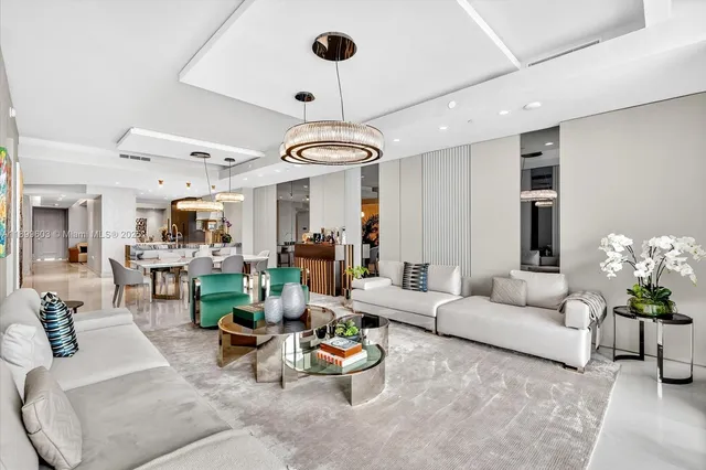 a living room with furniture and a chandelier