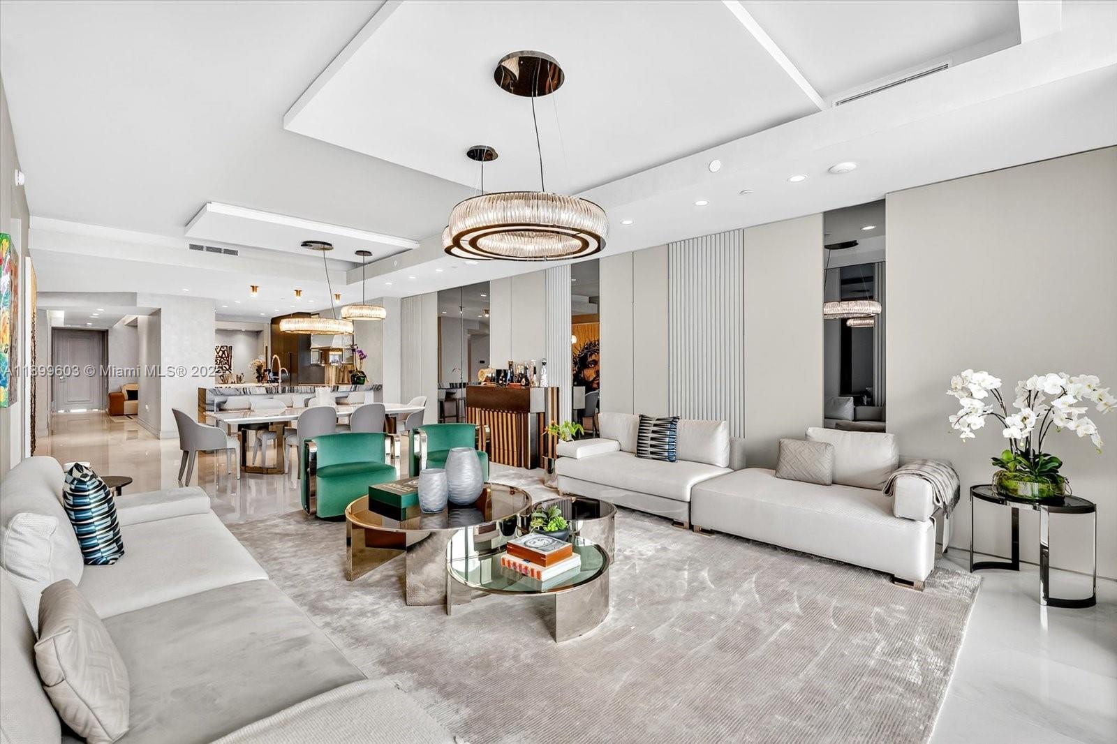 a living room with furniture and a chandelier