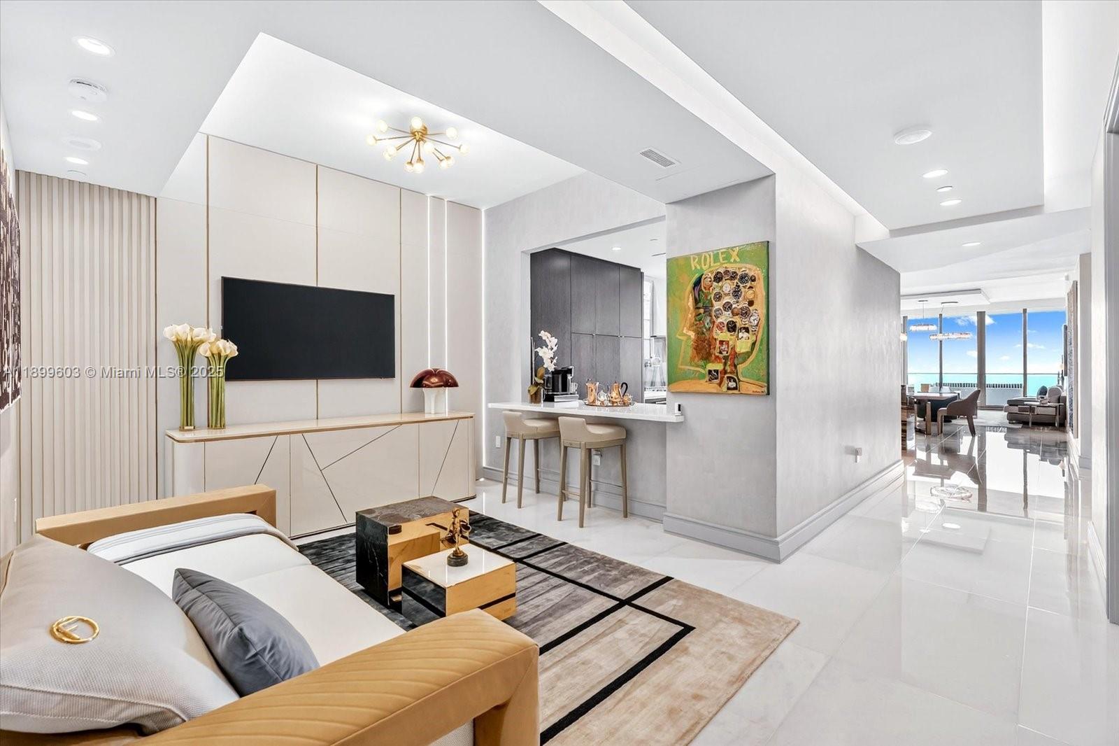 17901 Collins Avenue, Unit 3103 Sunny Isles Beach, FL 33160 - Photo 11 of 38 a living room with furniture and a flat screen tv