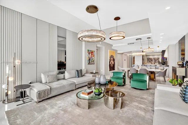 a living room with furniture and a chandelier