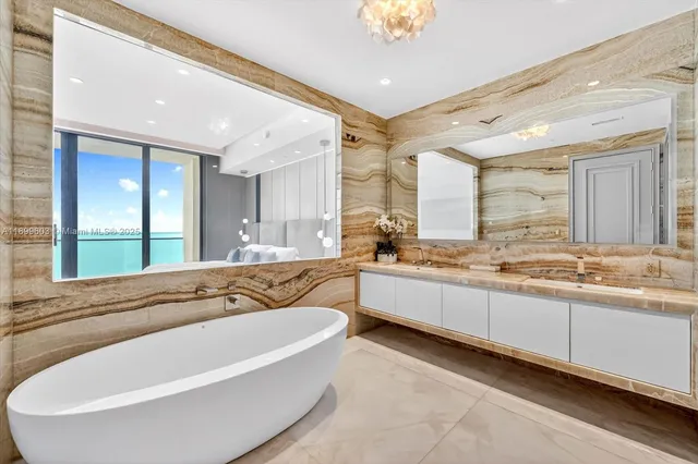 a spacious bathroom with a granite countertop tub sink and mirror