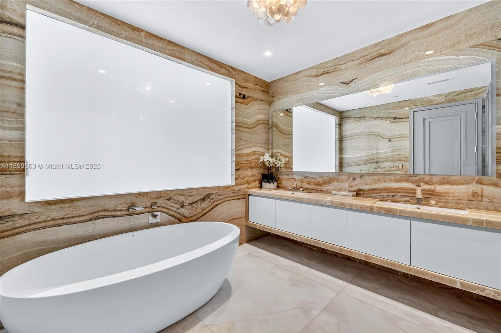 17901 Collins Avenue, Unit 3103 Sunny Isles Beach, FL 33160 - Photo 22 of 38 a bathroom with a bathtub and a sink