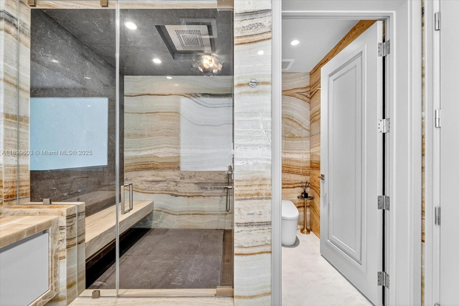 17901 Collins Avenue, Unit 3103 Sunny Isles Beach, FL 33160 - Photo 23 of 38 a bathroom with a granite countertop shower a sink and a mirror