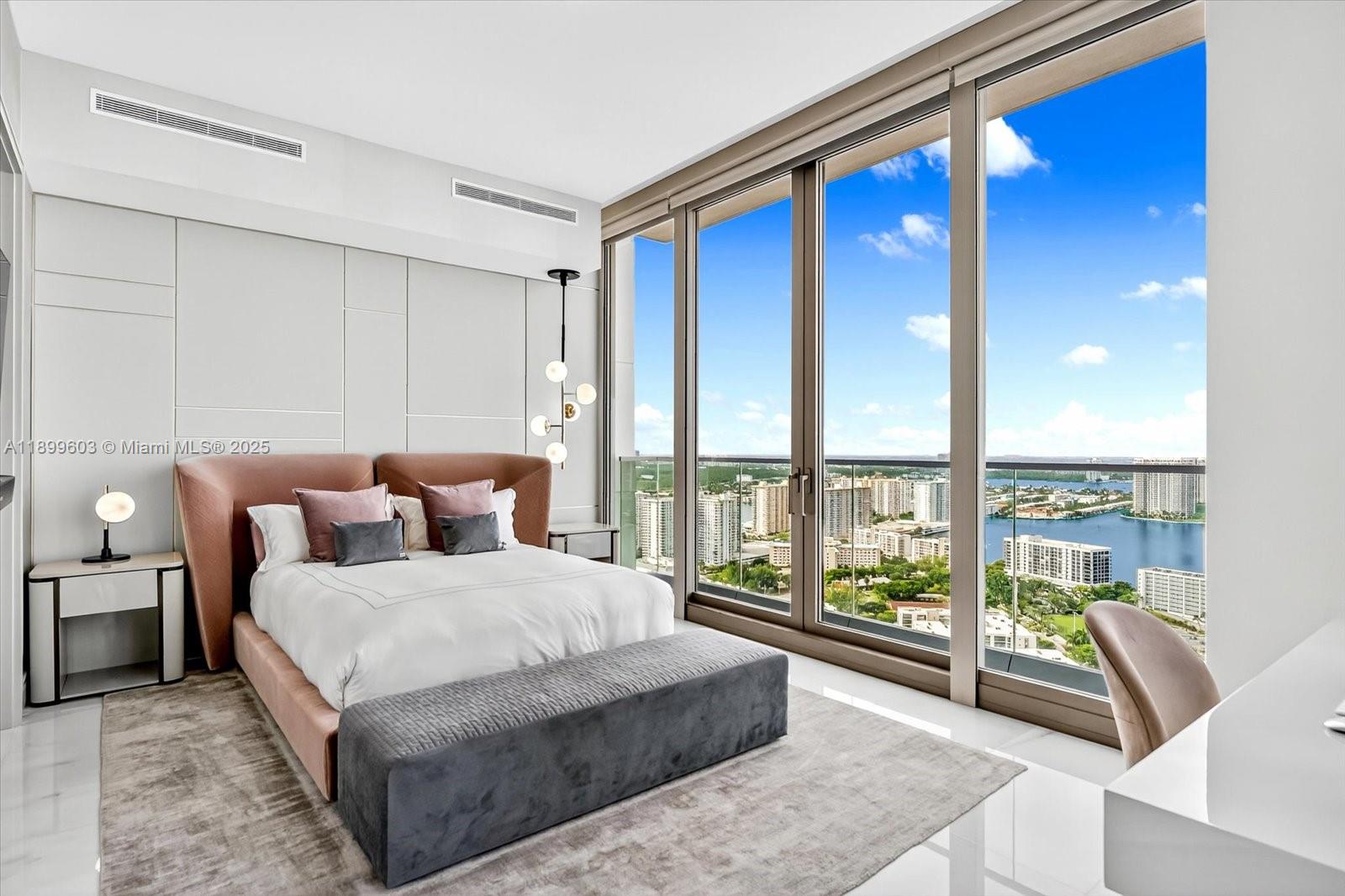 17901 Collins Avenue, Unit 3103 Sunny Isles Beach, FL 33160 - Photo 32 of 38 a spacious bedroom with a large bed and a large window
