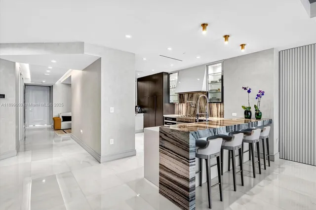 a kitchen with a refrigerator and a stove