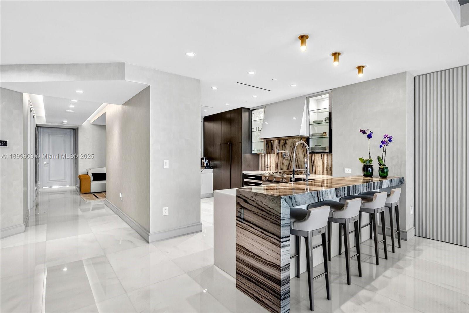 17901 Collins Avenue, Unit 3103 Sunny Isles Beach, FL 33160 - Photo 7 of 38 a kitchen with a refrigerator and a stove