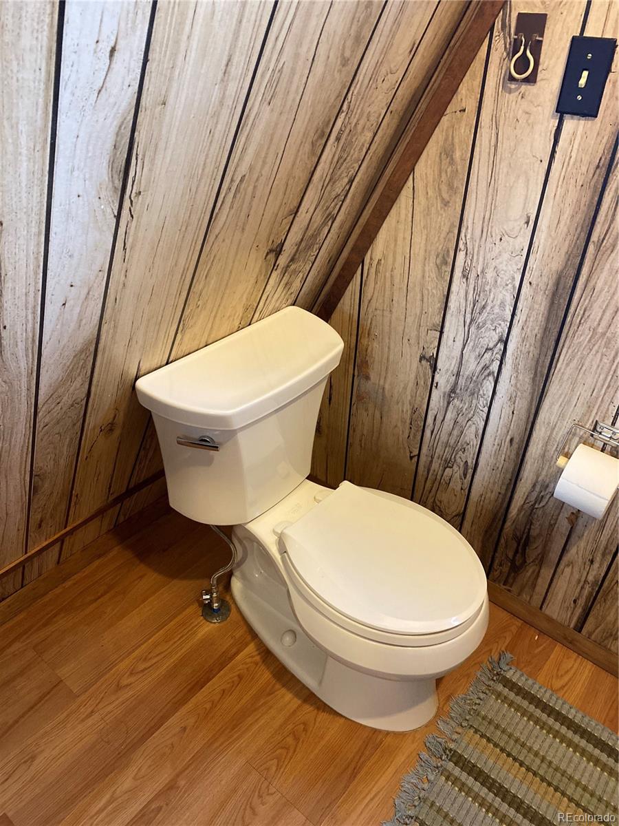 259 Bordenville Road Jefferson, CO 80456 - Photo 16 of 47 a white toilet sitting next to a small bathroom