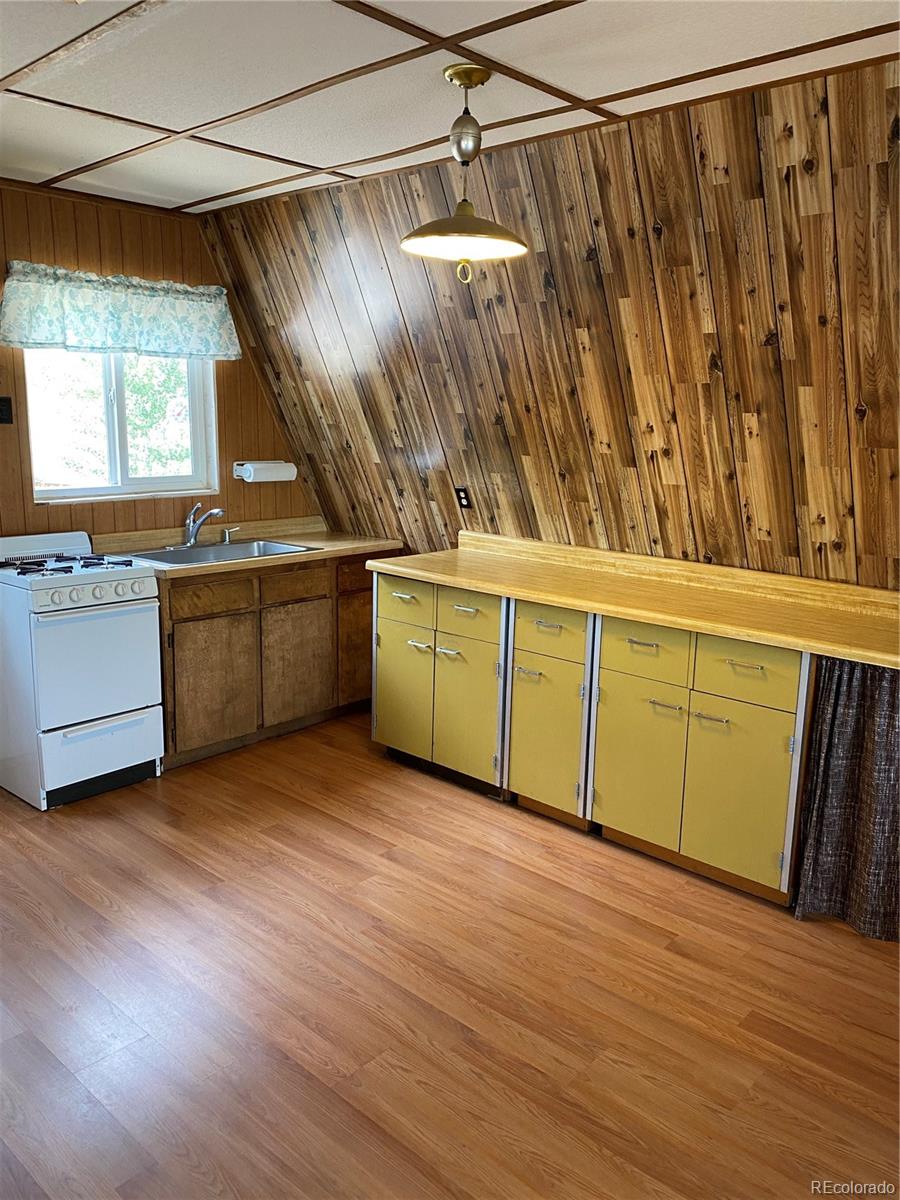 259 Bordenville Road Jefferson, CO 80456 - Photo 18 of 47 a view of a kitchen with wooden floor and electronic appliances