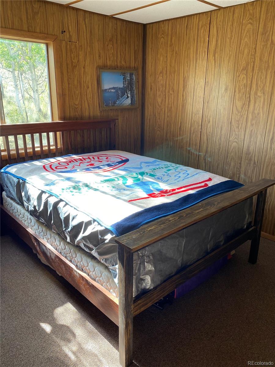 259 Bordenville Road Jefferson, CO 80456 - Photo 35 of 47 a bed sitting in a bedroom next to a window