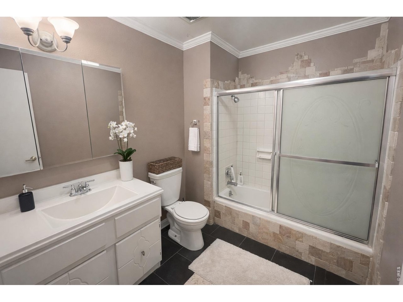 5588 Pioneer Road Boulder, CO 80301 - Photo 4 of 11 a bathroom with a sink a toilet a mirror and shower