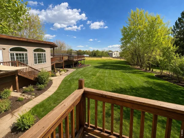 a view of a house with a yard from a balcony